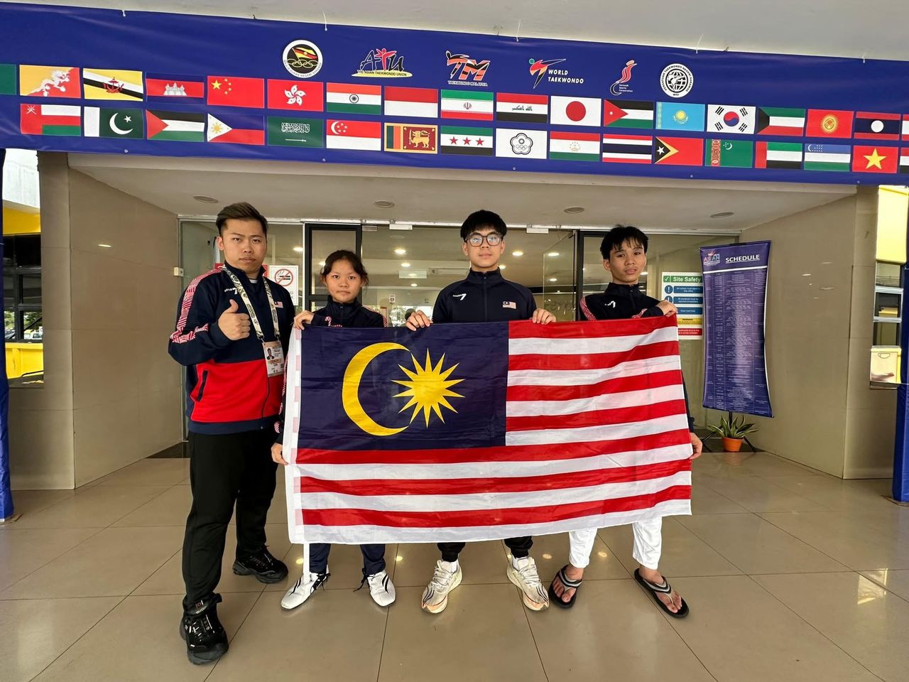 Newgen athletes with the Malaysian flag at the 2025 Asian Junior Taekwondo Championships