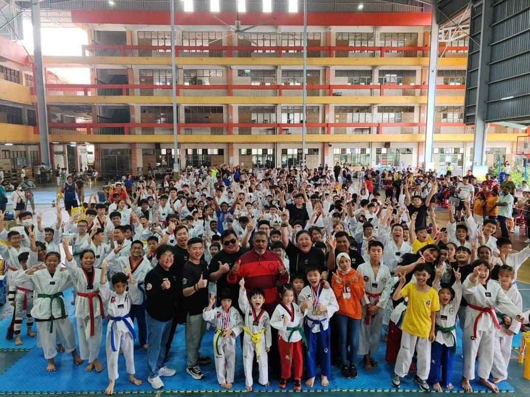 Large group of Newgen students, parents and coaches cheering at a club event